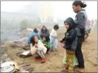  ?? AFP ?? This photograph taken in November 2016 shows refugees from Myanmar outside a temporary shelter in Manghai, Yunnan province.