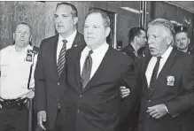  ?? RICHARD DREW THE ASSOCIATED PRESS ?? Harvey Weinstein is escorted in handcuffs to a courtroom in New York on Monday. Weinstein was due in court for arraignmen­t on charges alleging he committed a sex crime against a third woman.