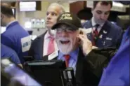  ?? RICHARD DREW — THE ASSOCIATED PRESS ?? Trader Peter Tuchman wears a “Dow 21,000” hat as he works on the floor of the New York Stock Exchange Wednesday.