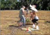  ?? SUBMITTED PHOTO ?? As part of “Seeds for Resistance,” demonstrat­ors plant wildflower seeds and a couple of pine trees Sunday at the area cleared by Sunoco for the Mariner East 2 Pipeline.