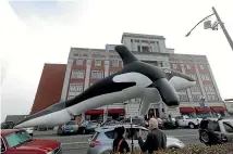  ?? AP ?? Supporters of dam removals stand near a giant inflatable orca outside a building in Tacoma, Washington, where the Southern Resident Killer Whale Recovery Task Force was meeting for a two-day work session.