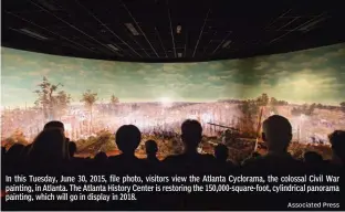  ?? Associated Press ?? In this Tuesday, June 30, 2015, file photo, visitors view the Atlanta Cyclorama, the colossal Civil War painting, in Atlanta. The Atlanta History Center is restoring the 150,000-square-foot, cylindrica­l panorama painting, which will go in display in...