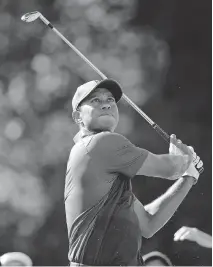  ?? CHUCK BURTON/THE ASSOCIATED PRESS ?? Tiger Woods watches a shot on his way to a share of the lead at the Wyndham Championsh­ip Friday.