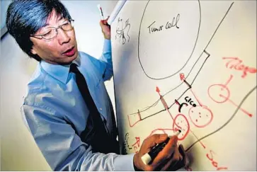  ?? Bob Chamberlin Los Angeles Times ?? PATRICK SOON-SHIONG, NantHealth’s chairman and CEO, said he was “pleased at the reaction to the IPO.” Above in 2005, he draws an illustrati­on about tumor cells and how they react to cancer treatment.