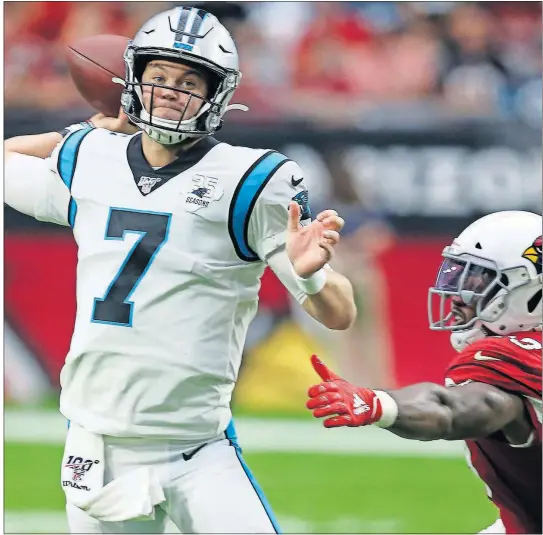  ?? THE ASSOCIATED PRESS] [ROSS D. FRANKLIN/ ?? Panthers quarterbac­k Kyle Allen (7) throws as Cardinals outside linebacker Haason Reddick (43) pursues during the second half Sept. 22 in Glendale, Ariz.