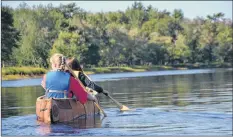  ?? LAWRENCE POWELL ?? Cedar Meuse Waterman and Karlee Peck of Bear River paddle the canoe they helped build at Kejimkujic National Park. They were leaving Jake’s Landing to go to Kedge Beach after a launch ceremony and smudging.