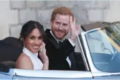  ?? — AFP ?? The newly- married Britain’s Prince Harry, Duke of Sussex, and Meghan Markle, Duchess of Sussex, leave Windsor Castle in Windsor on Saturday after their wedding to attend an evening reception at Frogmore House.