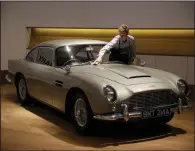  ?? AP file photo ?? A staff member of Bonhams Motoring auction house in London polishes the 1965 Aston Martin DB5 driven by actor Pierce Brosnan in the 1995 movie GoldenEye.