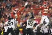  ?? JEFF ROBERSON AP ?? Chiefs’ Bryan Cook (6) and Jaylen Watson (35) pressure Jaguars QB Trevor Lawrence (16) on Saturday.