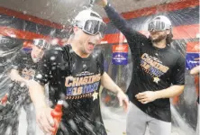  ?? Karen Warren / Houston Chronicle ?? Houston’s Jake Marisnick (right) and Alex Bregman celebrate in the clubhouse after sweeping Cleveland in an ALDS.