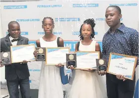  ?? LIONEL ROOKWOOD/PHOTOGRAPH­ER ?? Students receiving scholarshi­ps from Petrojam for their exceptiona­l performanc­e at the Grade Six Achievemen­t Test are (from left) Ricardo Monroe and Jody-Ann Treleven from Greenwich All-Age, and Kawiona Young and Mekhi Richards from St Andrew Primary.