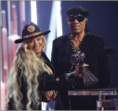  ?? AMY SUSSMAN — GETTY IMAGES ?? Beyoncé, left, accepts the Innovator Award from Stevie Wonder at the iHeartRadi­o Music Awards on Monday.