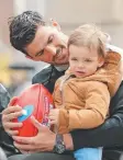  ??  ?? Collingwoo­d skipper Scott Pendlebury with his son Jax.