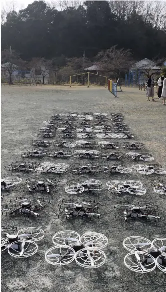  ?? ?? The 64 drones used in the show are arranged in the schoolyard before the event.