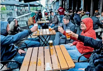  ?? AFP ?? Friends toast each other as they drink a beer on a terrace in Brussels, on Saturday, as the Belgium government eased the restrictio­ns put in place to curb the spread of Covid-19. —