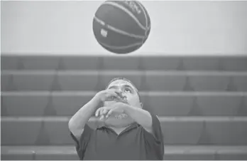  ?? MARK HENLE/THE REPUBLIC ?? David Solano catches a ball before the start of practice at Raul H. Castro Middle School in Phoenix.