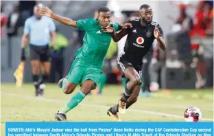  ?? — AFP ?? SOWETO: Ahli’s Muayid Jadour vies the ball from Pirates’ Deon Hotto during the CAF Confederat­ion Cup second leg semifinal between South Africa’s Orlando Pirates and Libya’s Al Ahly Tripoli at the Orlando Stadium on May 15, 2022.