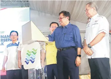  ?? — Photo by Kong Jun Liung ?? Abang Johari places his palm on a designated section of the rostrum to symbolical­ly launch the PLSB, witnessed by (from right) Wan Junaidi, Dr Sim and Chok.