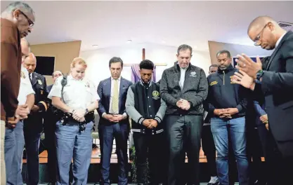  ?? ANNA MONEYMAKER/GETTY IMAGES ?? Mayor Brandon Scott, center, is surrounded by city officials during a prayer at a vigil Tuesday for victims of the Francis Scott Key Bridge collapse, at the Mount Olive Baptist Church in Baltimore.