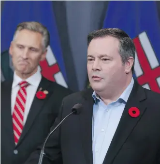  ?? GAVIN YOUNG ?? Calgary-Lougheed MLA Dave Rodney listens to Jason Kenney after Rodney announced that he would give up his seat to make way for a byelection to elect new UCP leader Kenney, on Sunday in Calgary.