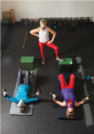  ??  ?? First time business owner Kelly Stranahan (standing) opened Core Fit Santa Fe in mid-October.