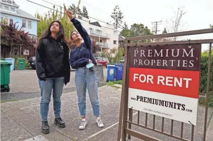  ?? ERIC RISBERG/AP ?? U.C., Berkeley freshmen Sanaa Sodhi, right, and Cheryl Tugade look for apartments in Berkeley, Calif., on March 29. Millions of college students in the U.S. are trying to find an affordable place to live as rents surge.