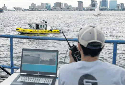  ?? AP PHOTO ?? In this Aug. 15, 2017 photo, computer scientist Mohamed Saad Ibn Seddik, of Sea Machines Robotics, uses a laptop to guide a boat outfitted with sensors and self-navigating software and capable of autonomous navigation in Boston Harbor.