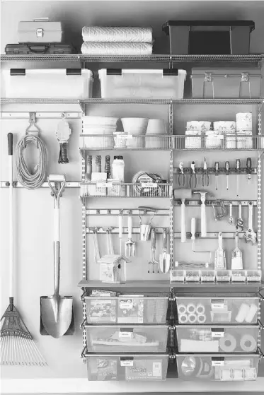  ??  ?? Shelving adds vertical storage and gets things off the floor. Clear bins allow you to see items stored inside, while hooks and pegboard for hanging tools and implements keeps them in sight.