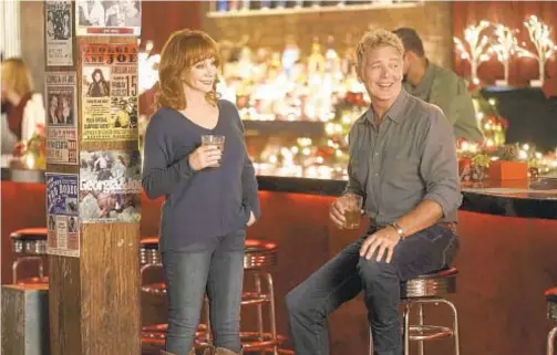  ?? LIFETIME ?? Reba McEntire and John Schneider in “Reba McEntire’s Christmas in Tune.”