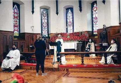  ?? Photos by Tom Reel / Staff photograph­er ?? The Rev. Ann Benton Fraser gives a sermon as St. Mark’s Episcopal Church records its Christmas Day service on Tuesday for a virtual presentati­on.