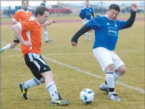  ?? NEWS PHOTO SEAN ROONEY ?? Sam Roman (right) of Medicine Hat Wild FC goes for a ball during the Keith Sykes Memorial soccer tournament Friday at Rotary Track field.