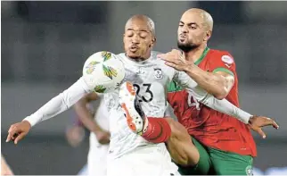  ?? /Reuters ?? No quarter given: SA's Thapelo Morena shields the ball from Morocco's Sofyan Amrabat in the last-16 match. Bafana will have to show similar determinat­ion against Cape Verde on Saturday.