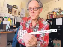 ?? SUSAN MONTOYA BRYAN/ ASSOCIATED PRESS ?? Don Hancock, with the Southwest Research and Informatio­n Center, holds a promotiona­l flyswatter in his office in Albuquerqu­e. The printed message sells the Waste Isolation Pilot Plant as the solution to nuclear pollution.