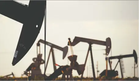  ?? CHARLIE RIEDEL/THE ASSOCIATED PRESS FILES ?? Oil prices plunged for a fifth day Thursday to their lowest since January 2019. China’s coronaviru­s struggles have dragged U.S. crude more than 23 per cent since the start of 2020. Above, pump jacks work near Lovington, N.M.