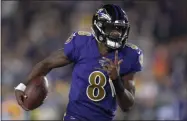  ?? KYUSUNG GONG - THE ASSOCIATED PRESS ?? Baltimore Ravens quarterbac­k Lamar Jackson runs against the Los Angeles Rams during the first half of an NFL football game Monday, Nov. 25, 2019, in Los Angeles.