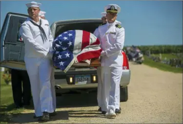  ?? CHRIS ZOELLER — GLOBE-GAZETTE VIA AP, FILE ?? U.S. Navy sailors remove the casket with the remains of Seaman First Class Leon Arickx from a hearse at Sacred Heart Cemetery where they will be put to rest in Osage, Iowa. Arickx’ remains, which were unidentifi­able after his death after the Japanese attack at Pearl Harbor in 1941, were identified through DNA testing earlier this year.