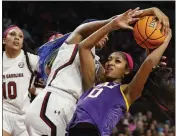  ?? NELL REDMOND – THE ASSOCIATED PRESS ?? South Carolina forward Aliyah Boston, center, strips the ball from LSU forward Angel Reese during Sunday's game.