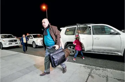  ?? PHOTO: REUTERS ?? Fuad Sharef, an Iraqi with an immigratio­n visa who was prevented with his family from boarding a flight to New York a week ago, carries his bag at Erbil Internatio­nal Airport in Iraq to fly to Nashville, Tennessee, their new home.