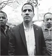  ??  ?? Self-declared interim President Juan Guaido is flanked by bodyguards Thursday in Caracas, Venezuela. NATACHA PISARENKO/AP