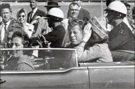  ?? JIM ALTGENS / ASSOCIATED PRESS 1963 ?? President John F. Kennedy waves from the car in his Dallas motorcade on Nov. 22, 1963, moments before he was shot to death. With him is his wife, Jacqueline; in the front seat are Gov. John Connally of Texas and his wife, Nellie.