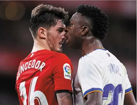  ?? — AP ?? Too close: real madrid’s Vinicius Junior (right) confrontin­g athletic bilbao’s Unai Vencedor. Below: Karim benzema celebratin­g after scoring one of his two goals.