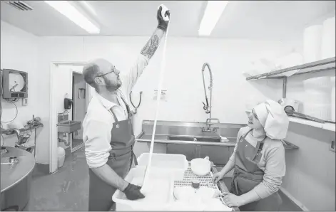  ?? RYAN TAPLIN / THE CHRONICLE HERALD ?? Ciro Comencini shows how much the mozzarella can stretch as he makes cheese with his 13-year-old daughter Linda at their family’s operation in Woodville.