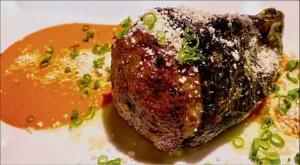  ?? Susie Davidson Powell / For the Times Union ?? A roasted poblano is stuffed with ground lamb .