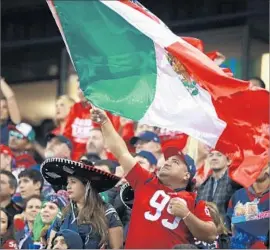  ?? Hector Vivas LatinConte­nt ?? A HOUSTON TEXANS fan waves a f lag at last year’s game with the Oakland Raiders at Mexico City’s Azteca Stadium. The Raiders play there again Sunday.