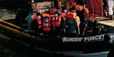  ??  ?? Picked up at sea: Channel migrants are brought to shore at Dover by the Border Force New arrivals: Asylum seekers at the former Napier Barracks