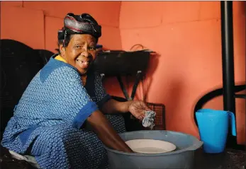  ??  ?? She is 100 years old, but Nokhawulez­ile Jadi, of Siyanyanze­la Informal settlement in Philippi, still does the dishes and helps with food preparatio­n. She remembers queueing for many hours in the heat on the day she first voted.