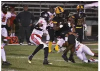  ?? (Pine Bluff Commercial/I.C. Murrell) ?? Watson Chapel running back Robert Brown tries to spin off Jacksonvil­le tacklers during the first half Friday at Wildcat Stadium.