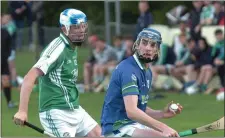  ??  ?? Cormac Rowe keeps the ball away from Gorey’s John Doyle.