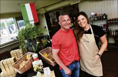  ?? Arnold Gold / Hearst Connecticu­t Media ?? ▶ Clockwise from above, Nonna Gina’s Prepared Foods and Gelateria owners Robert Criscuolo and his wife, Carla Maravalle, at the business in Branford on Thursday; pots of pomodoro sauce at Nonna Gina’s; a variety of panini for sale, and copies of handwritte­n recipes in Italian from Anastasia “Gina” DiNatale, kept in a binder at Nonna Gina’s.