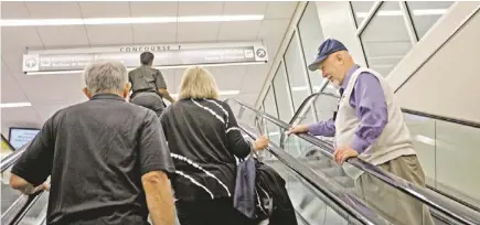  ?? DAVID GOLDMAN/AP ?? The Rev. Frank Colladay Jr. talks to passengers trying to make a connecting flight at Hartsfield-Jackson Internatio­nal Airport in Atlanta, where Colladay serves as chaplain.